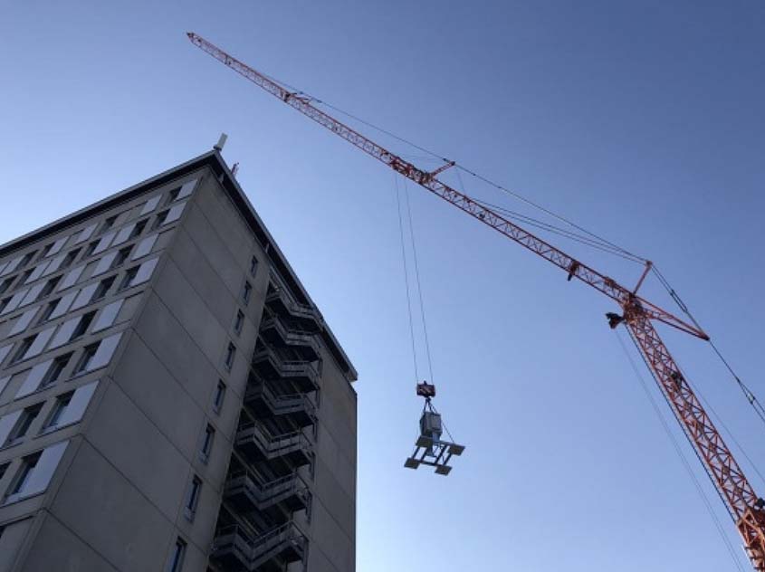 Pollen monitoring device being lifted by crane